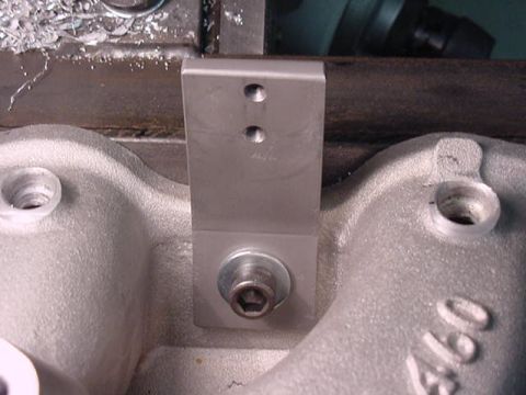 1979 Ford Bronco - Close-up of a metal bracket attached to an engine component, with visible machining debris.