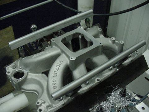 1979 Ford Bronco - Close-up of a silver intake manifold, identified as a 'VICTOR 460', with fuel rails installed.