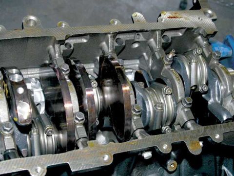 2007 Ford Mustang - Photo of a physical crankshaft and rods in an engine block, not a technical document.