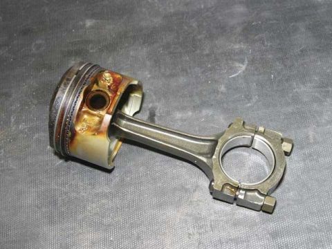 2007 Ford Mustang - Photo of a physical piston and connecting rod, not a technical document.
