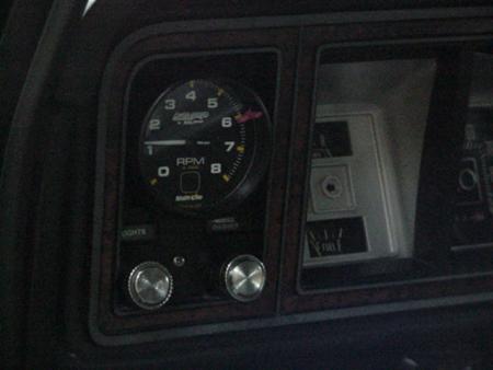 1979 Ford Bronco - Close-up of a tachometer and other dashboard gauges within a vehicle's interior.