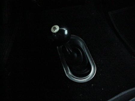 1979 Ford Bronco - Close-up of a black 8-ball shift knob with a chrome trim boot surround.