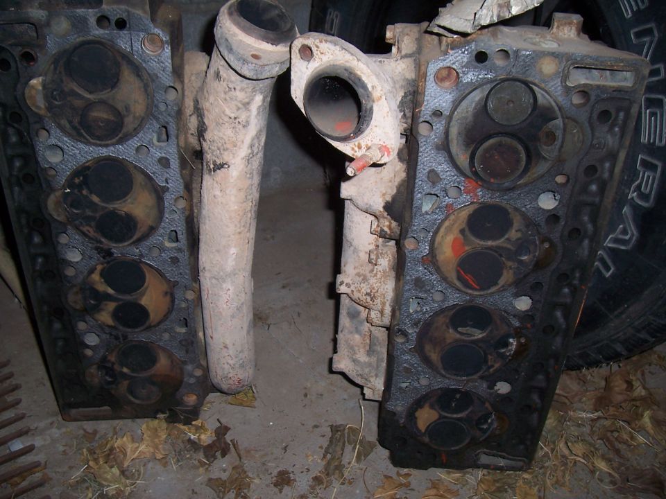 Two cylinder heads and an intake manifold piece