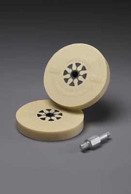 1992 Ford Bronco - Two beige abrasive discs with black centers are shown, with a silver threaded adapter in the foreground.