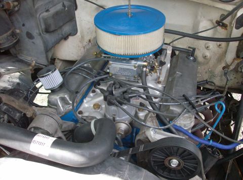 1989 Ford Bronco - The image shows a close-up view of a V8 engine bay, likely from a Ford Bronco. Visible components include a Holley carburetor with an air f…