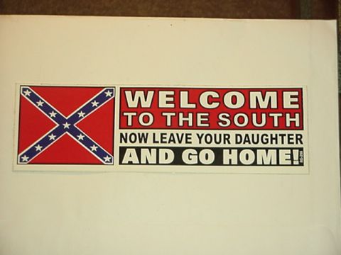 1979 Ford Bronco - A sticker the Confederate flag and a provocative message is displayed on a white surface.
