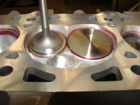 2007 Ford Mustang - Close-up photo of physical valves in a cylinder head, not a technical document.