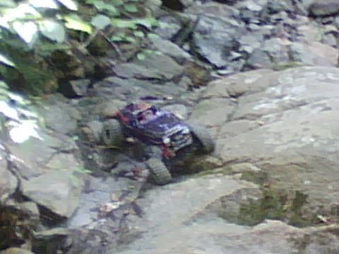 1996 Ford Bronco - RC rock crawler navigates a challenging rocky path.