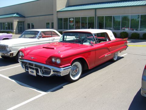 2007 Ford Mustang - A classic red convertible with a white roof is parked in a lot next to another vehicle.