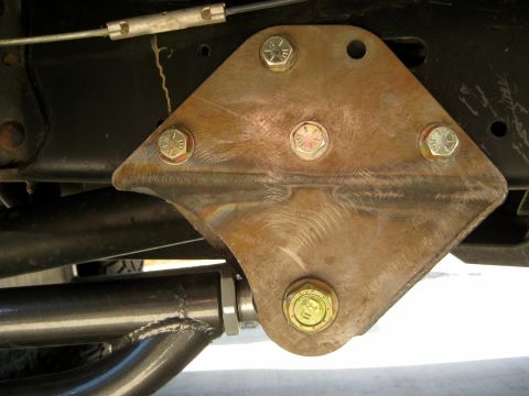 1996 Ford Bronco - Custom suspension bracket, likely an aftermarket modification, attached to the vehicle's frame.