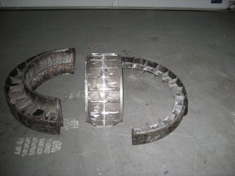 1991 Ford Bronco - Damaged turbine fan components are shown disassembled on a concrete surface.