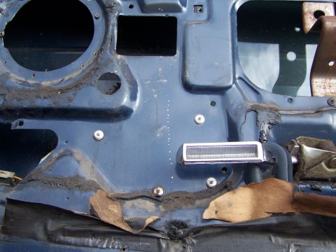 1986 Ford Bronco - Close-up of a vehicle's interior door panel, showing exposed metal and insulation.