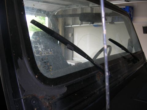 1991 Jeep Wrangler - Interior view of a 1991 Jeep Wrangler windshield showing wipers and some rust.