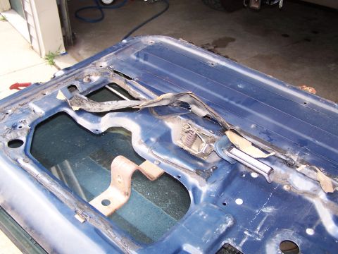 1986 Ford Bronco - The interior of a vehicle door shows its internal components and wear.