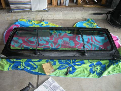 1991 Jeep Wrangler - A disassembled Jeep Wrangler windshield frame is laid out on towels, ready for work.