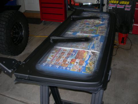 1991 Jeep Wrangler - A Jeep Wrangler door is taped off and covered with newspaper, ready for a fresh coat of paint.