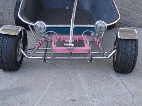 1973 Ford Ranchero - Head-on low view of a custom show cart built on a wheelbarrow tub, running a chromed independent front suspension with pink-bodied coilover…