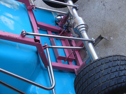 1973 Ford Ranchero - A custom go-kart chassis is viewed from a low angle, revealing its blue body and pink frame.