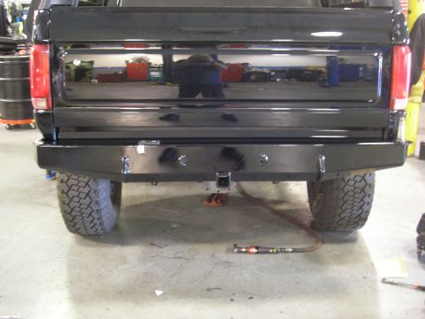 1995 Ford Bronco - Rear view of a 1995 Ford Bronco showing the aftermarket bumper and tire.