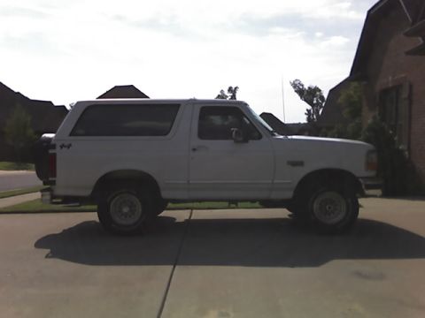 1996 Ford Bronco - Side view of a white 1996 Ford Bronco parked on a paved surface.