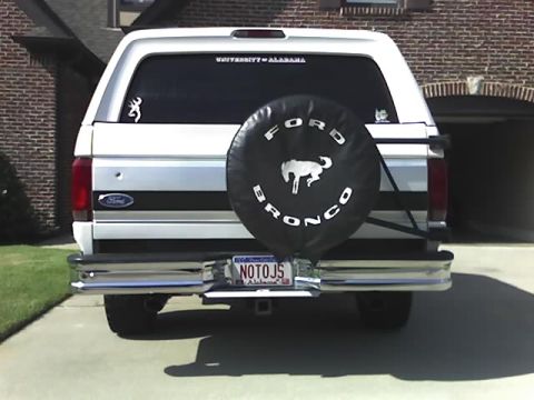 1996 Ford Bronco - Rear view of a white Ford Bronco, equipped with a spare tire cover and Alabama license plate.