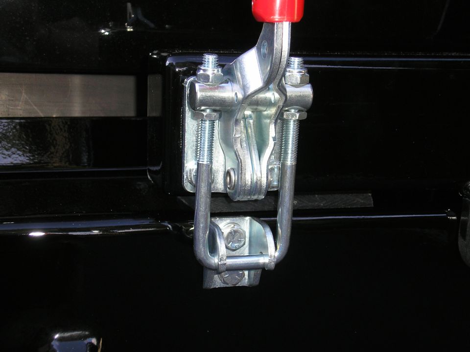 Zinc toggle clamp U-hook latched to catch bracket on black steel bumper