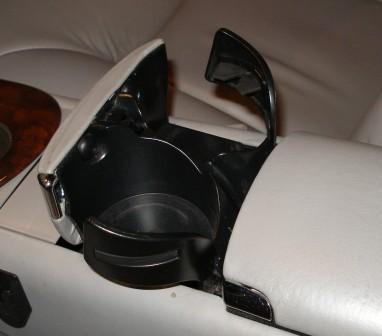 1998 Lincoln Mark VIII - Close-up of a vehicle's interior cup holder and console area.