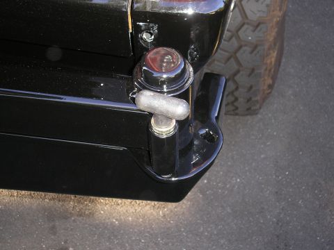 1995 Ford Bronco - Rear view of a black 1995 Ford Bronco, highlighting the bumper, tow hitch, and taillight.