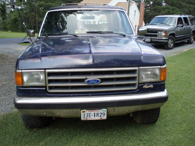 Blue 1989 Ford Bronco front view with a chrome grille and bumper