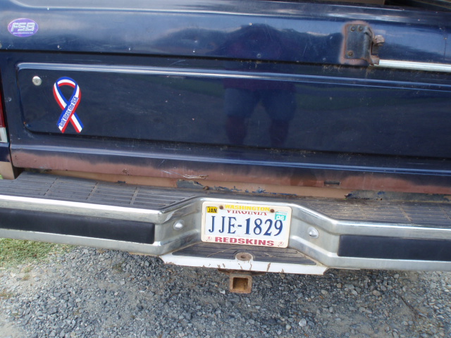 Blue Ford tailgate with ribbon decal and Virginia Redskins plate JJE-1829