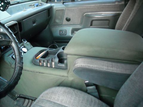 1990 Ford C-150 (Centurion Conversions) - Interior view of a 1990 Ford C-150 (Centurion Conversions) showing the center console, dashboard, and driver's side.