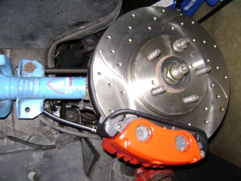 1991 Ford Taurus - Close-up view of a vehicle's upgraded brake system, showing the caliper and rotor.