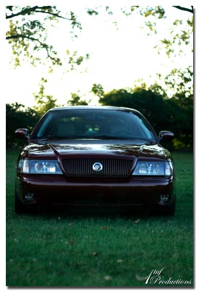2003 Mercury Marauder - The front grille and headlights of a maroon 2003 Mercury Marauder are visible.