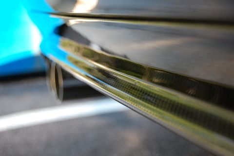 2002 BMW M3 - Detail shot of a car's rear end, focusing on the carbon fiber diffuser and exhaust pipe.