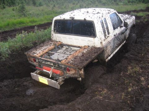 1990 Ford F-250 - This 1990 Ford F-250 is deeply stuck in the mud, showing its rear end.