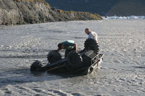 1990 Chevrolet Suburban - Two men attempt to recover an ATV that has become stuck in a rocky riverbed.