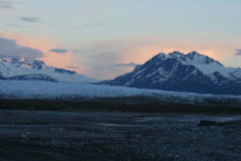 1990 Chevrolet Suburban - A blurry, wide shot of a mountainous landscape with a glacier in the foreground during twilight.