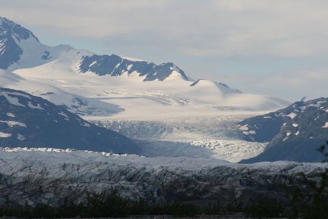 1990 Chevrolet Suburban - A vast glacial landscape with snow-capped mountains in the background and a large glacier in the foreground.