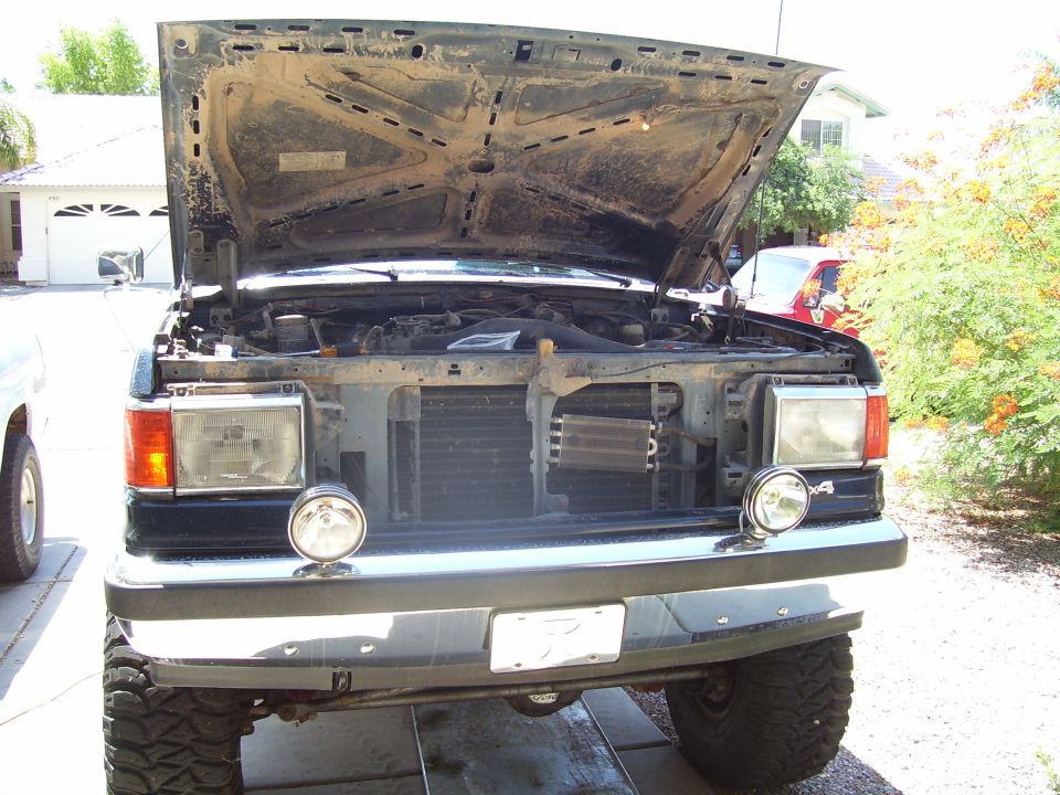 1991 Ford Bronco front view with hood open, showing engine and aftermarket lights.
