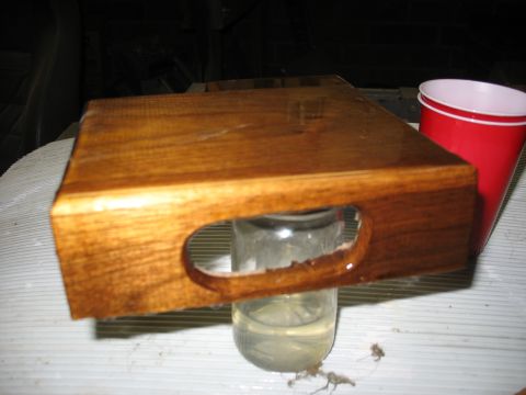 1995 Ford C-350 (Centurion Conversions) - A wooden tray with a handle is shown, resting on a glass jar with liquid.