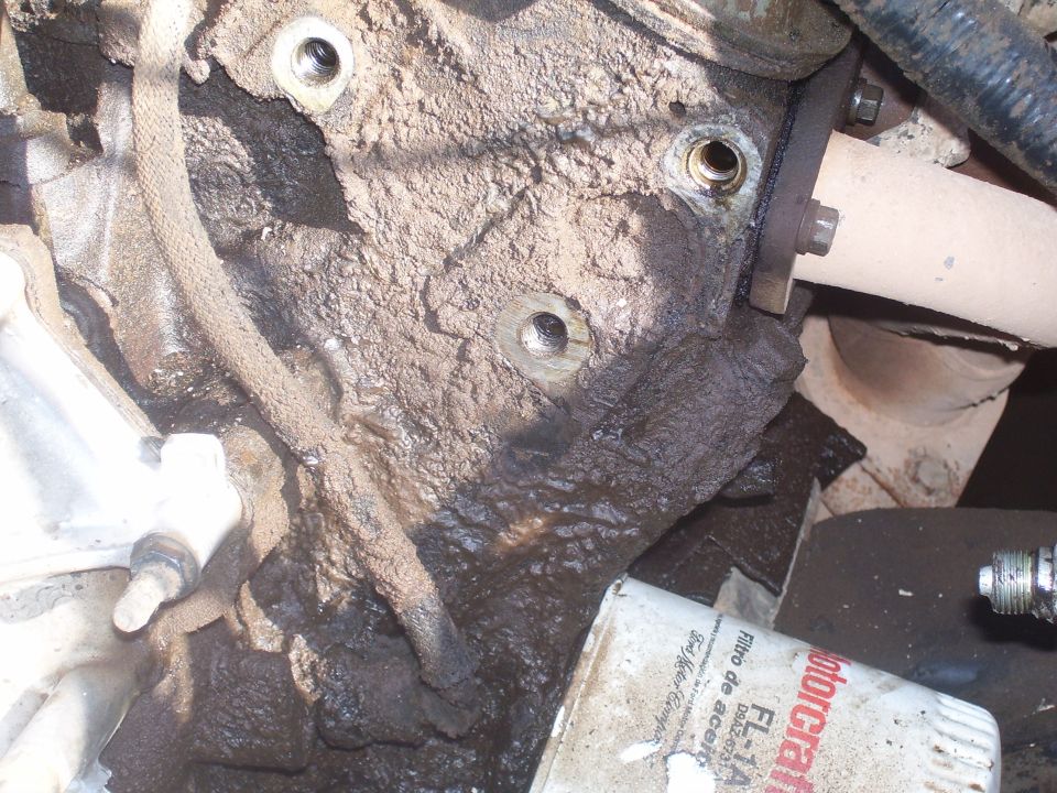 Heavily soiled engine block with exhaust manifold and oil filter.