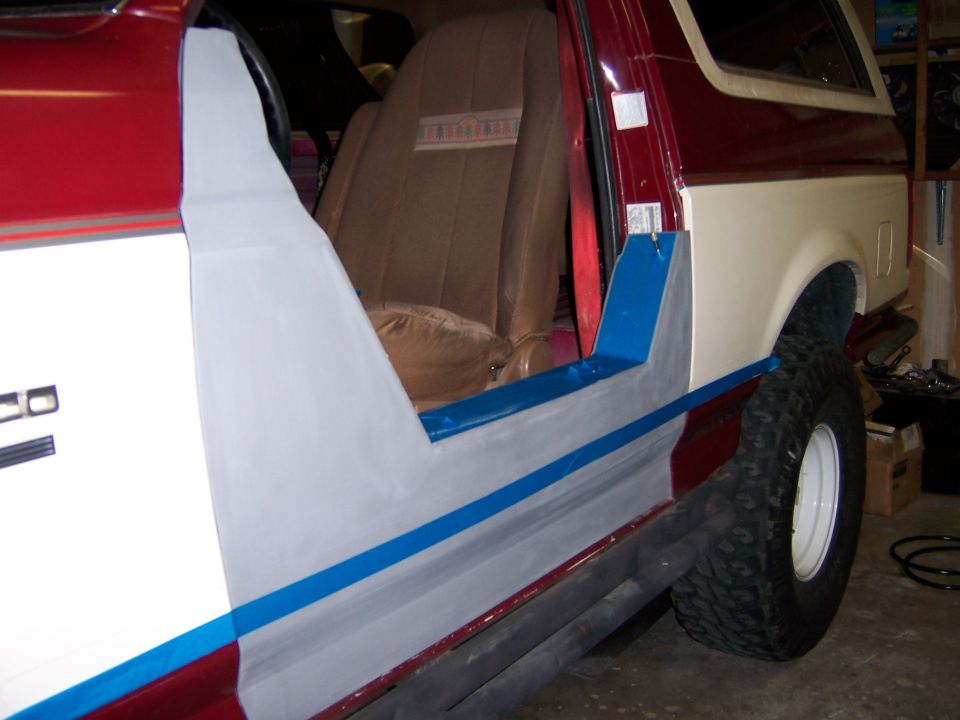 1991 Ford Bronco side panel being prepped for paint, showing door opening and interior seat