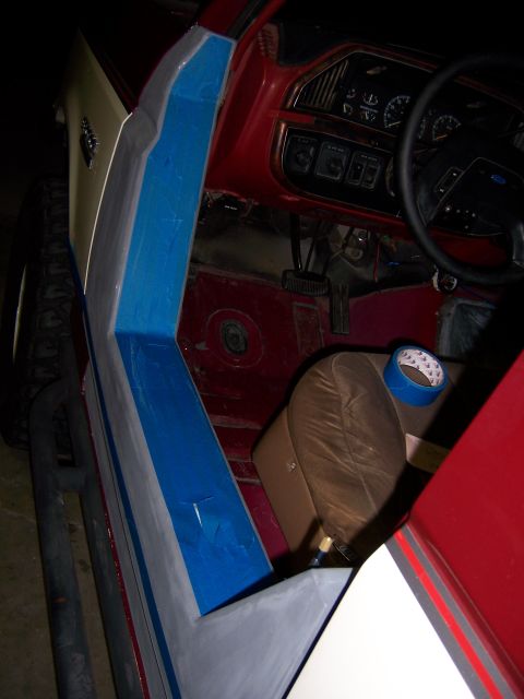 1991 Ford Bronco - The interior of a 1991 Ford Bronco is shown, focusing on the door panel and dashboard area during a project.