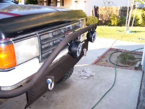 1991 Ford Bronco - Close-up of a truck's front end, showing the grille and a heavy-duty bumper with auxiliary lights.