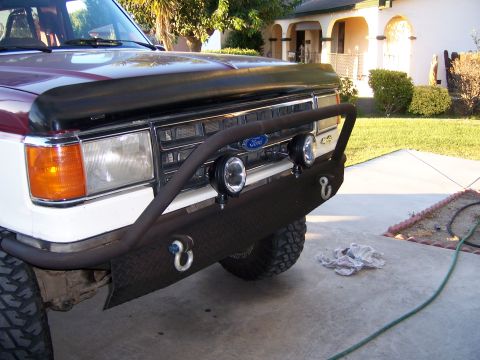 1991 Ford Bronco - The front of a 1991 Ford Bronco a custom bumper with auxiliary lights and tow hooks.