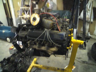 1979 Ford Bronco - Engine assembly mounted on an engine stand in a workshop setting.