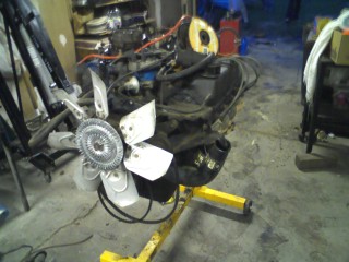 1979 Ford Bronco - Engine assembly on a stand, with the Supermotors logo in the foreground.