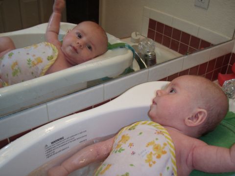 1997 Ford F-250 - A baby enjoys bath time, with its reflection visible in the mirror above the tub.