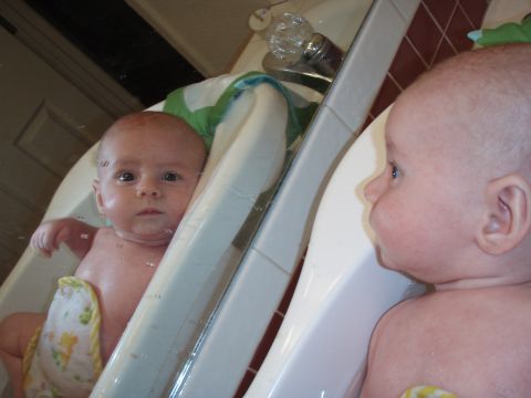 1997 Ford F-250 - A baby sits in a bathtub, looking at its reflection in the tub's surface.