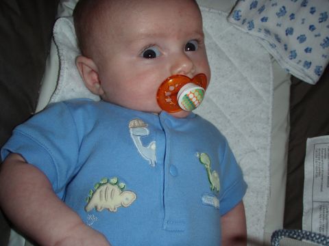 1997 Ford F-250 - A baby is shown wearing blue pajamas with dinosaur graphics and an orange pacifier.